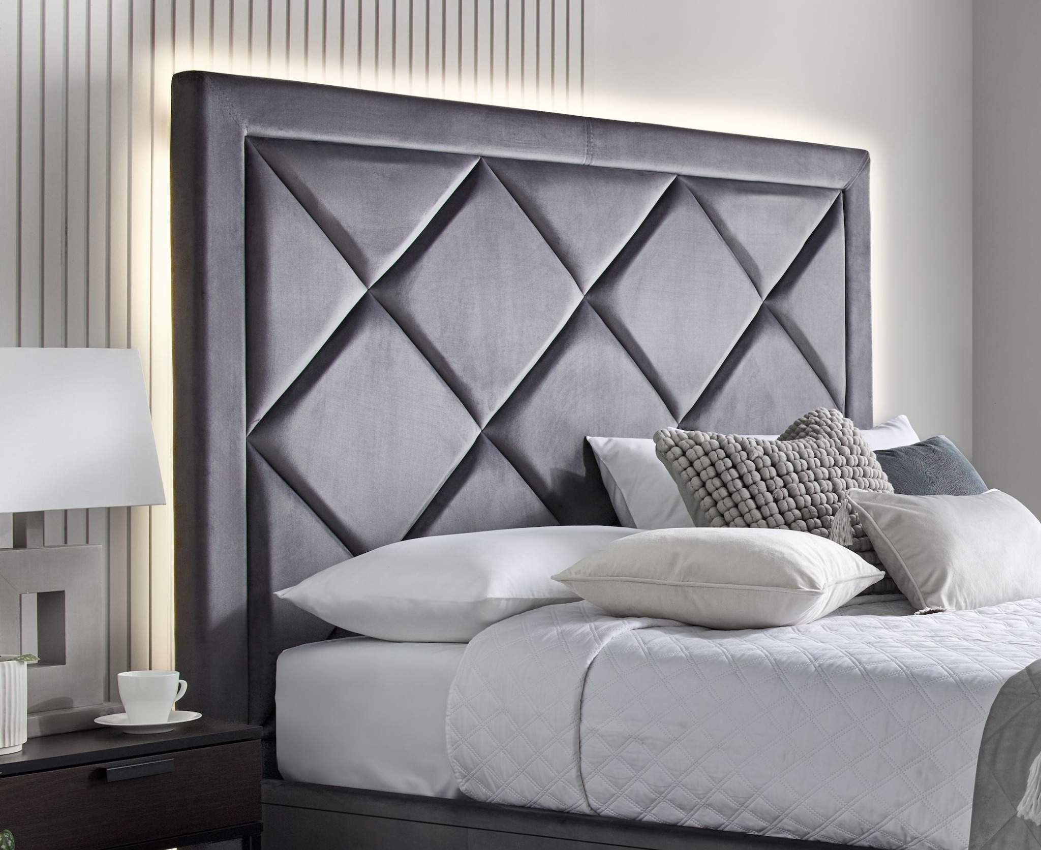 LuXre grey upholstered TV bed in a bedroom